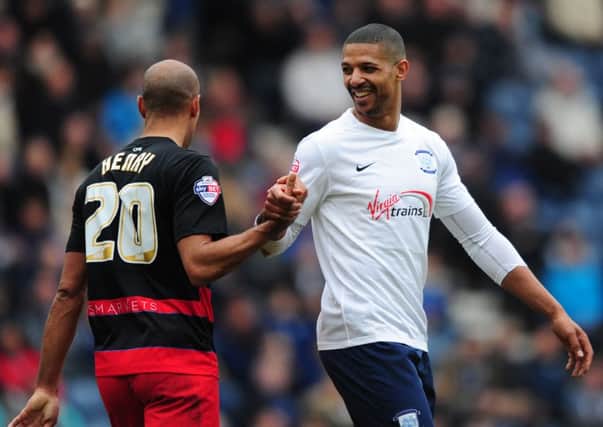 Jermaine Beckford exchanges a word with QPR's Karl Henry