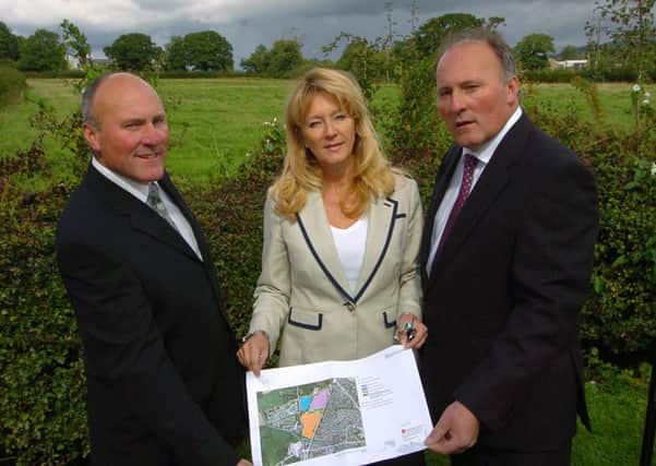 Developer Robert Chippendale and family are hoping to convert 15 acres of land to the west of the A6 at Garstang into a major housing and business development.
Robert (right) is pictured with twin brother Andrew and sister Amanda Harris holding plans of the development, with some of the land in the background.   PIC BY ROB LOCK
9-9-2013