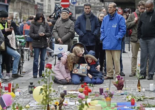 People mourn for the victims of the bombings at the Place de la Bourse in the centre of Brussels. See main letter