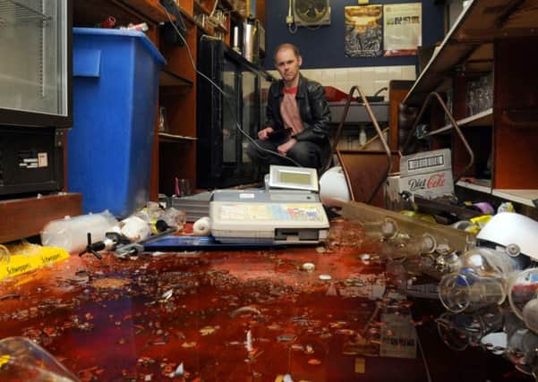 Councillor James Grundy looks at the damage