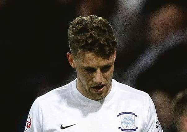 Preston North End's Calum Woods leaves the pitch with an injury against Fulham