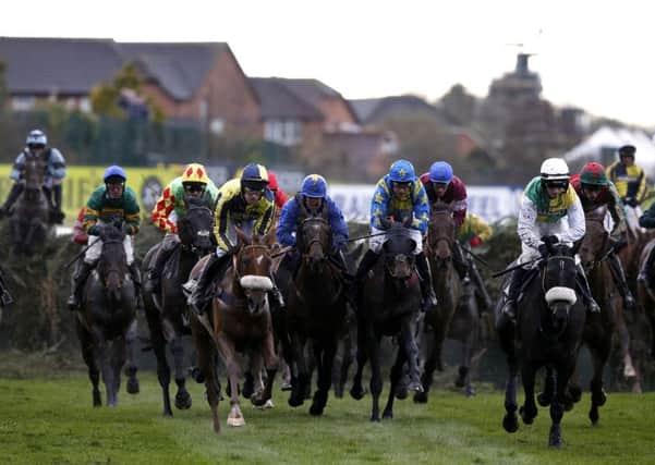 Runners and riders during the  Grand National Chase