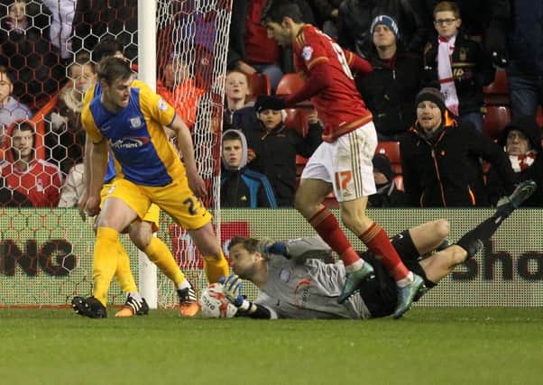 Anders Lindegaard gets down among the boots in PNE's defeat at Nottingham Forest last month