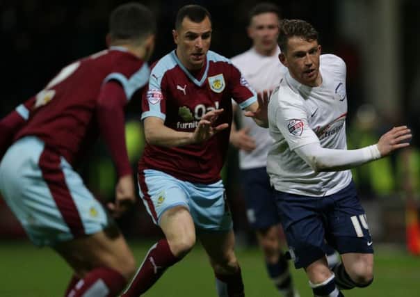 PNE striker Joe Garner takes on Burnley's Dean Marney