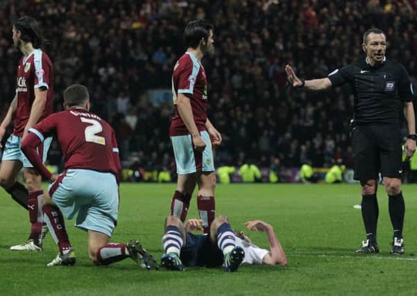 Greg Cunningham appears to be fouled by Burnley's Matthew Lowton and  Joey Barton in the penalty area but referee Kevin Friend gave the free-kick outside the area