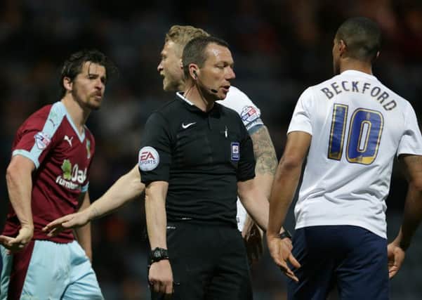Referee Kevin Friend separates Burnley's Joey Barton and Preston North End's Jermaine Beckford