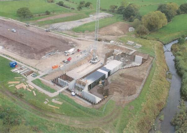 Work on the flood defence scheme, pictured today, is now expected to be completed in August