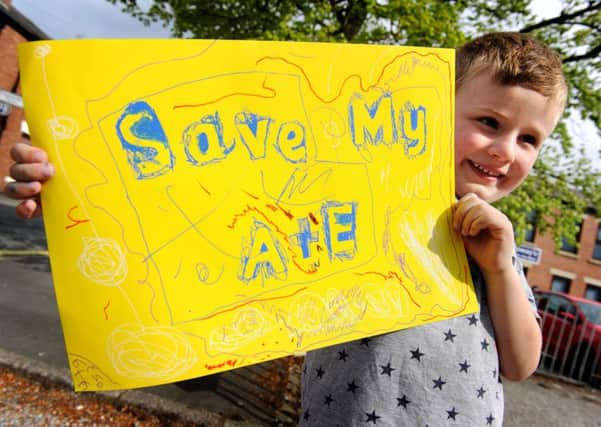 Five-year-old Thomas Burrows with his sign