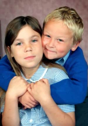 PHOTO IAN ROBINSON My hero sister, Jacob Hill, aged six , gives his sister, Storm, eight, a hug after she saved him from drowning in Leyland near Preston.