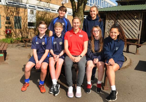 Holly Bradshaw, centre, visits pupils, from left, Ollie Johnson, Ethan Edwards, Daniel Barber (back left), Darcie Jackson-Henderson (back right), Kaitlan Woodhead and Tamia Concepcion, in her former school at Parklands High School, Chorley, part of the Sky Sports Living for Sport masterclass workshops.