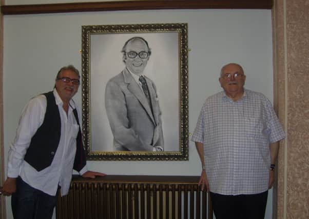 Dave Miles, president of the Eric Morecambe Appreciation Society, with Eric's nephew Michael 'Wiggy' Threlfall and the painting of Eric at Morecambe Town Hall.