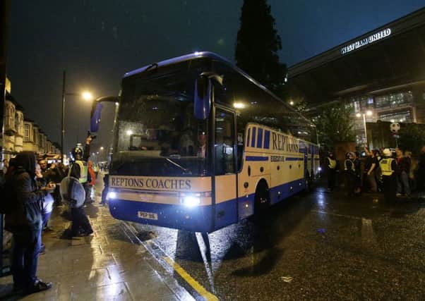 The replacement Manchester United team coach leaves Upton Park on Tuesday night after the original one was damaged by missiles thrown by fans