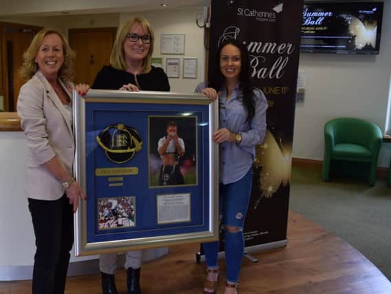 Hospice supporter Margaret Calvert and daughter Laura donate signed Paul Gascoigne memorabilia for the auction at the St Catherines Summer Ball, to event organiser Lynne Whittaker
