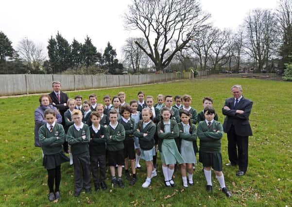 Staff and children from St Catherine's Primary School have managed to save an 850 year old oak tree that was being cut down at the former convent next door.  Pictured are some of the pupils with coun Mary Green, coun Michael Green and Tony Green.