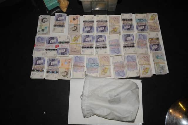 Money and tobacco found during a raid by HMRC officers on the home of Iqbal Haji in Whalley Street, Blackburn