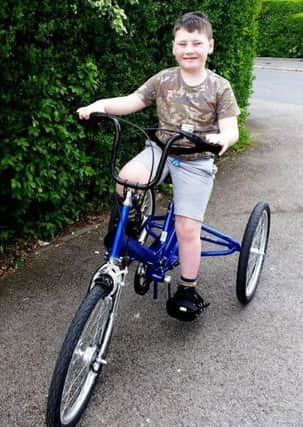 Ethan Kennard, 7, from Ribbleton, Preston. Ethan has  cerebral palsy and right hemiplegia but was given a new tricycle by charity Caudwell Children because he wasn't bale to ride a two-wheeled bike.