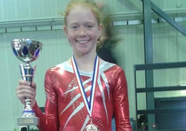 Madelaine Routledge, 11, originally from Penwrotham but moved to France three years ago. The gymnast poses here with the team zonal cup and has been slected for the French Women's Artistic National Championships.