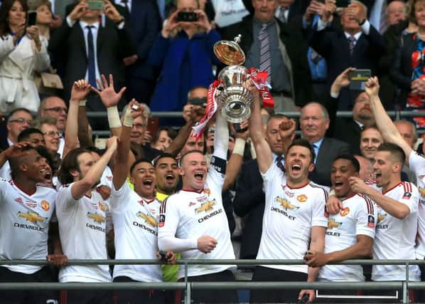 Manchester United's Wayne Rooney (left) and Michael Carrick (right) lift the FA Cup