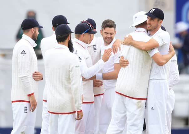Jimmy Anderson (centre) celebrates with his team-mates after winning the first Test against Sri Lanka at Headingley