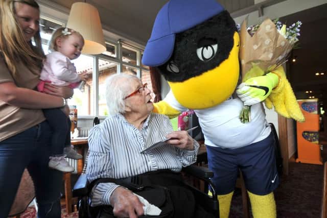 Photo Neil Cross
Massive PNE fan May Robinson celebrating her 100th birthday with a surprise visit from Deepdale Duck.