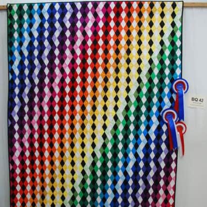 Mum-sister duo Carole and Emma Galbraith, from Barton and own Quilter's Quarters in Longridge saw their Starburst and Prism of Light designs awarded first and third place respectively at the Qiults UK competition in Malvern at the Three Counties Show Ground.

Picture: Prism of Light quilt