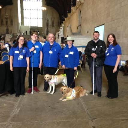 Alan Hughes, centre, with his guide dog Kim were part of a delegation who visited the House of Commons to lobby for it to become illegal for a taxi driver to refuse to take a guide dog