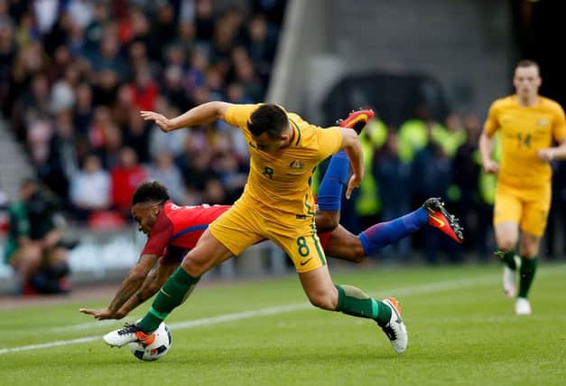 England's Raheem Sterling and Australia's Bailey Wright battle for the ball