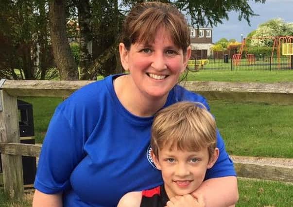 William and mum Becky Bradley as the eight-year-old attempts or run 26.2 miles in a month to raise money for The British Heart Foundation.