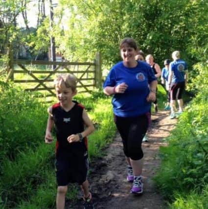 William and mum Becky Bradley as the eight-year-old attempts or run 26.2 miles in a month to raise money for The British Heart Foundation.