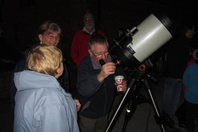 Members of Euxtronomy looking through a telescope