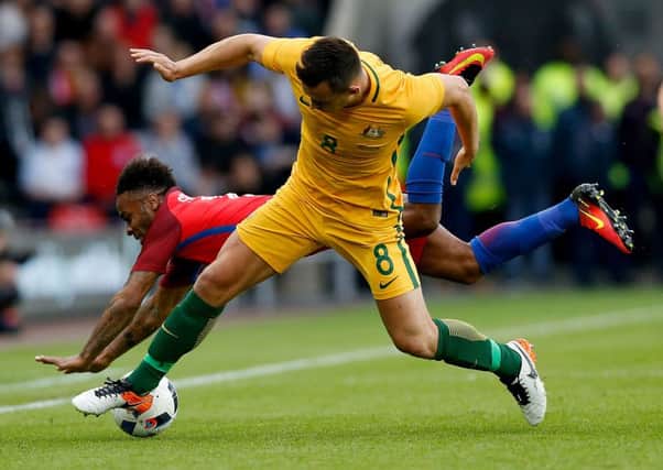 England's Raheem Sterling and Australia's Bailey Wright battle for the ball