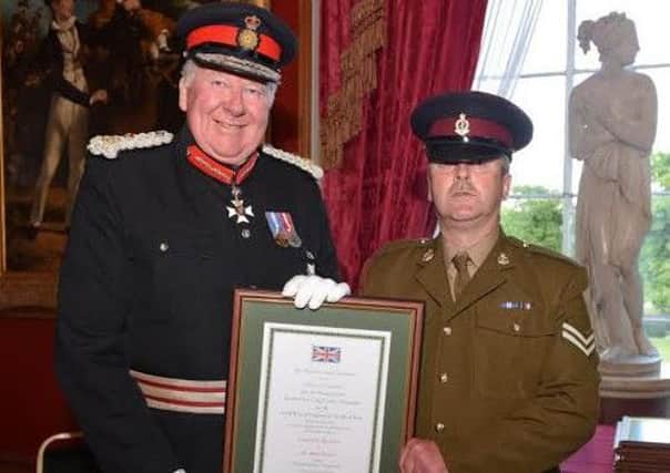 Lord Shuttleworth KCVO, Her Majestys Lord-Lieutenant for Lancashire, presents Her Majestys Lord-Lieutenants Certificate of Merit to Farington army reservist Corporal Gary Mackerial, 49