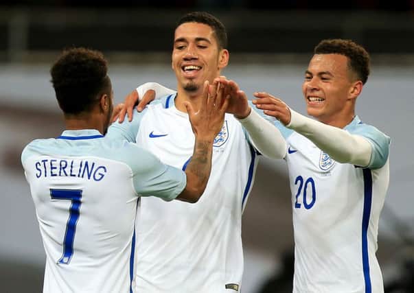 Chris Smalling (centre) after scoring the only goal in England's recent friendly win against Portugal at Wembley