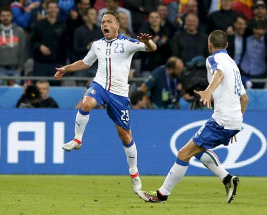 Italy's Emanuele Giaccherini, left, celebrates after scoring his side's first goal during the Euro 2016 Group E soccer match against Belgium