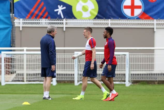 England manager Roy Hodgson (left) speaks to jamie Vardy and Raheem Sterling during a training session