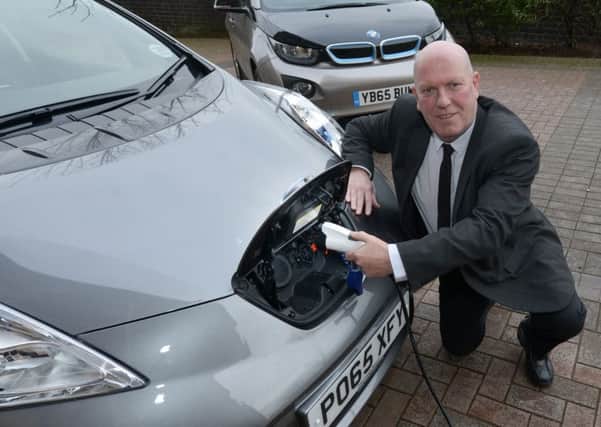 Lancashire County  Councillor John Fillis with the electric vehicles at County Hall