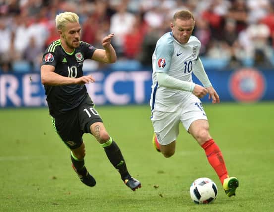 England's Wayne Rooney and Wales' Aaron Ramsey (left) battle for the ball