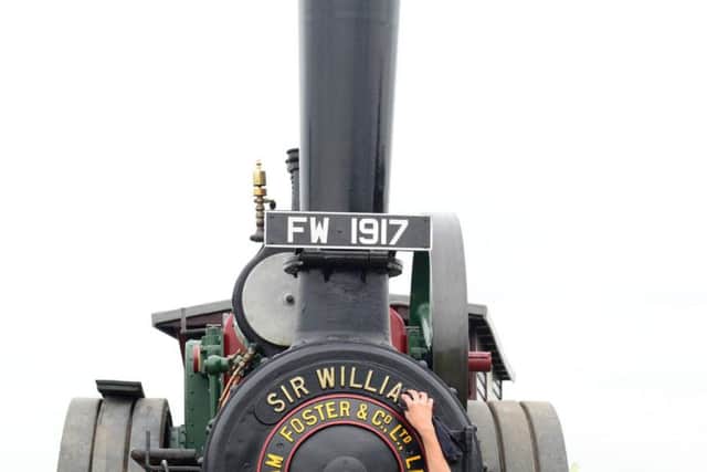 Grace Smith puts a shine to her dad's steam engine