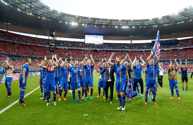 Iceland players celebrate qualifying for the last 16 round after their win over Austria