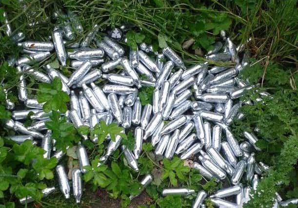 Nitrous oxide canisters dumped yards from a school in Bamber Bridge.