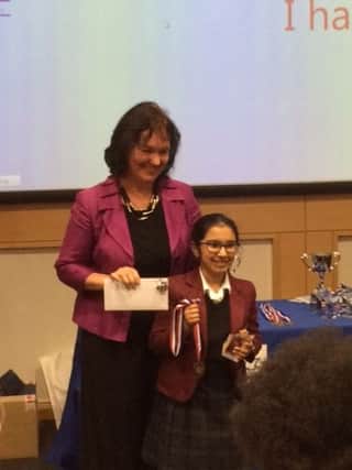 Meghna Shajil receiving her Spelling Bee award..