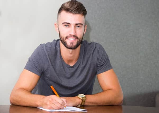 Liam Wakefield signs on the dotted line with Morecambe. Picture: Matt Rushton