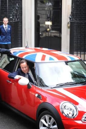 Prime Minister David Cameron at a photo shoot with a Mini but where was it built, asks one reader