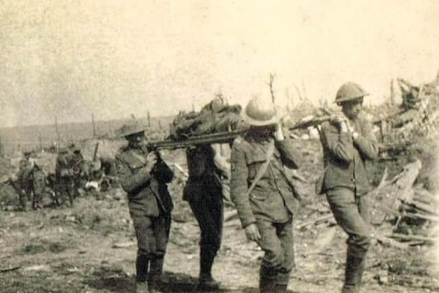 Soldiers of 4th Battalion South Lancashires carry a casualty from the battlefield, September 15, 1916