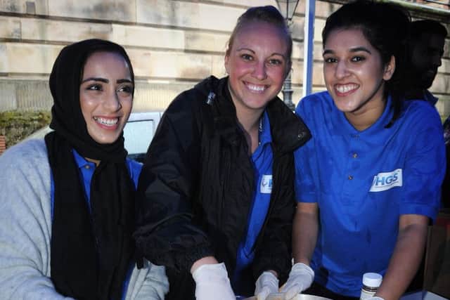 Staff from Hinduja Global Solutions call centre in Preston organised a Feed the Homeless event in the Flag Market to coincide with Ramadan.Pictured serving out food are L-R: Famida Member, Jenna Atkins and Shifa Patel.  PIC BY ROB LOCK30-6-2016