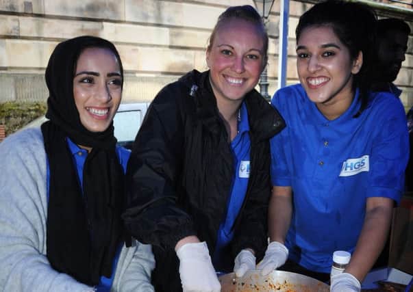 Staff from Hinduja Global Solutions call centre in Preston organised a Feed the Homeless event in the Flag Market to coincide with Ramadan.
Pictured serving out food are L-R: Famida Member, Jenna Atkins and Shifa Patel.  PIC BY ROB LOCK
30-6-2016