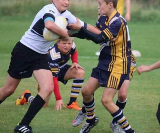 Left: Ethan Fitzgerald, 13, from Chorley, playing rugby for the Chorley Panthers.
