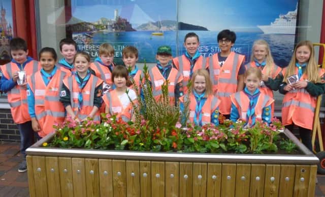 Youngsters from Astley Village Scout Group and their leaders planted up the floral displays between Market Walk and the covered market. The plants were donated by Chris Ball of Longlands Farm who has a stall on the market.