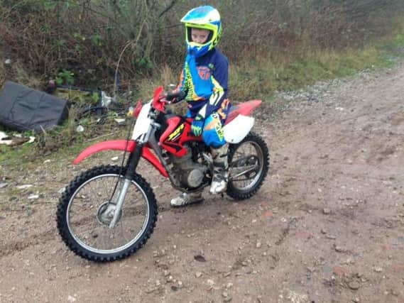 POLICE APPEAL: Ryan Hughes, 12, from Charnock Richard, on his Honda XR100 motorcycle which has been stolen by burglars.