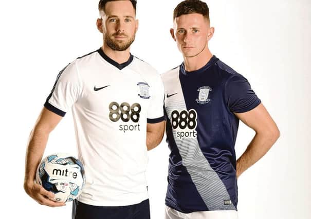 Greg Cunningham models PNE's home kit, with Alan Browne (right) sporting the new navy blue and white away strip